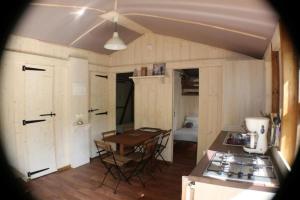 eine Küche mit einem Tisch und einem Herd im Zimmer in der Unterkunft Cabane 3 étoiles - Piscine - eec0cc in Belguiral