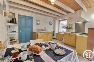 a kitchen with a table with food on it at Le havre de kerariou in Trébeurden