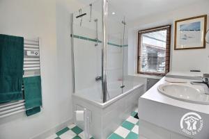 a white bathroom with a sink and a shower at Le havre de kerariou in Trébeurden +24 photos