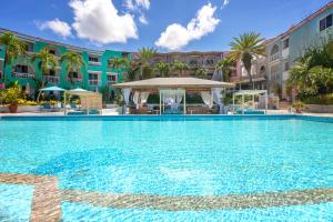 a large swimming pool in front of a building at Ocean Point Beach Resort & Spa Adults Only in Saint Johnʼs