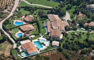 an aerial view of a house with a swimming pool at Hotiday Baja Sardinia Saline in Cala Bitta