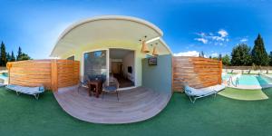 a circular house with a deck and a swimming pool at M&B Luxury Suites Charaki in Haraki