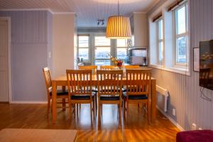 a dining room with a table and chairs at Rorbuene Svolvær Havn in Svolvær