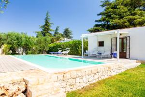 a swimming pool in the backyard of a house at Trulli del Capo by MONHOLIDAY in Monopoli