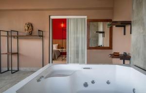 a large white bath tub in a bathroom at Ola Hotel in Antalya