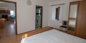 a bedroom with a bed and a large mirror at Flora in Sveti Nicola