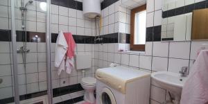 a white bathroom with a toilet and a sink at Flora in Sveti Nicola +22 photos