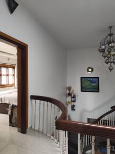 ein Schlafzimmer mit einem Bett und eine Treppe mit einem Kronleuchter in der Unterkunft Retreat Rivera where Serenity Meets the River in Green Island