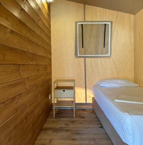 a small bedroom with a bed and a window at Armenistis Mediterranean Camping Village in Sarti