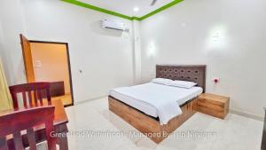 Ένα ή περισσότερα κρεβάτια σε δωμάτιο στο Greenland Waterfront Kundapura