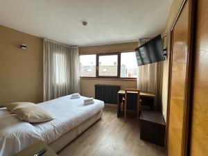 a hotel room with a bed and a desk at Hotel Santa Catalina by Bossh Hotels! in A Coruña +81 photos