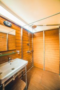 a bathroom with a sink and a shower at Armenistis Mediterranean Camping Village in Sarti