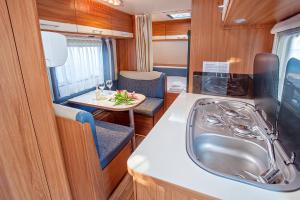 a kitchen with a sink and a table at Armenistis Mediterranean Camping Village in Sarti +46 photos