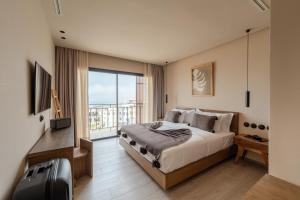 a bedroom with a bed and a large window at Nobi Boutique Surf Hotel Taghazout in Tamraght Ouzdar +65 photos