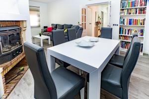 a living room with a table and chairs and a fireplace at Villa Daniela in Retamar
