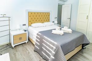 a bedroom with a large bed with towels on it at Villa Daniela in Retamar
