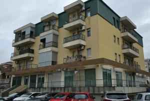a tall building with cars parked in front of it at KASIJA Apartman in Podgorica