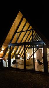 a large building with a roof with a living room at Green Zone - Vikendica in Dubrave Gornje