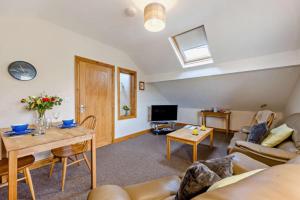 a living room with a couch and a table at Gwilym's Stable in Builth Wells