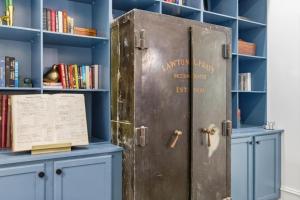 an old metal locker in a library with books at The Ray Soulful King Studio Pool in Jacksonville +61 photos