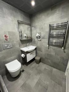 a bathroom with a toilet and a sink at Nexus By Taksim Hotel in Istanbul