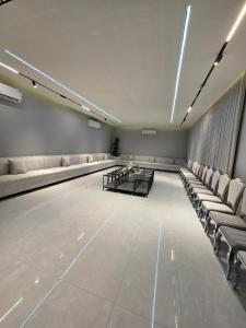 a large empty room with couches and tables and lights at Levana Chalet in Al Madinah +74 photos