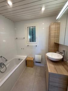 a white bathroom with a tub and a sink at 6AMB38 Superbe Villa avec terrasses dans résidence avec piscine commune in Collioure