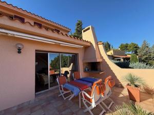 a patio with a table and chairs on a house at 6AMB38 Superbe Villa avec terrasses dans résidence avec piscine commune in Collioure