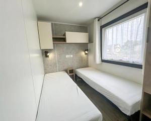 a small room with two beds and a window at GK - Elégance & Confort, 3ch, 2sdb, piscine, plages et campagne in Lattes +35 photos