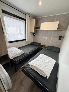 a small room with two beds and a window at GK - Elégance & Confort, 3ch, 2sdb, piscine, plages et campagne in Lattes