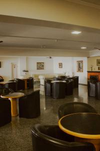 a dining room with tables and chairs in a room at Rovi Plaza Hotel in Serra Negra +72 photos