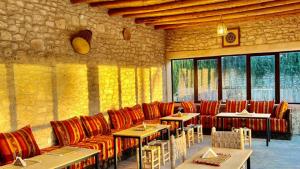 a restaurant with tables and chairs in a room at Dar Ayman Essaouira in Essaouira
