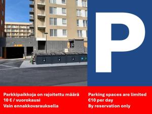 a picture of a building with a parking spaces are limited at Studio Apartments Pukkila in Turku
