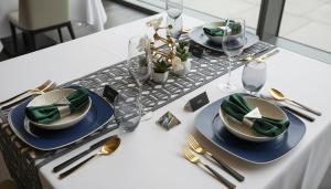 a table with plates and silverware on top of it at Hotel Sternen in Gurtnellen