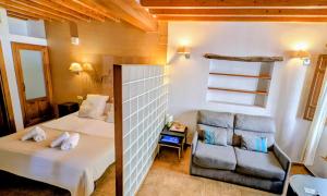 a bedroom with a bed and a chair at Apartamentos Alhambra in Granada +92 photos