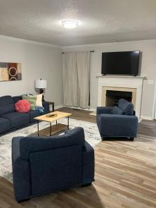 a living room with two blue couches and a fireplace at Your special Stay in Birmingham