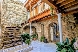 a stone building with a staircase and a stone wall at Apartamentos Alhambra in Granada