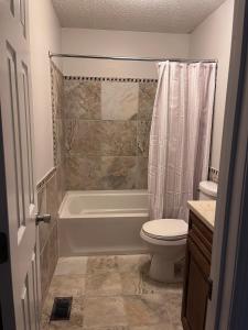 a bathroom with a tub and a toilet and a shower at Your special Stay in Birmingham