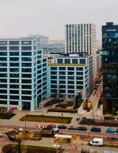 a city with tall buildings and a parking lot with cars at Platinum Towers Apartment A family place in Warsaw