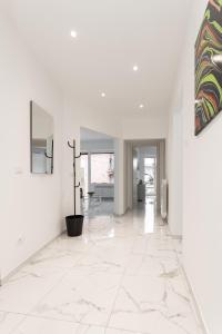 a hallway with white walls and white tile floors at Il Sogno a due passi dal mare vicino PORTOFINO in Rapallo