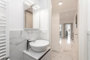a white bathroom with a sink and a mirror at Il Sogno a due passi dal mare vicino PORTOFINO in Rapallo +19 photos