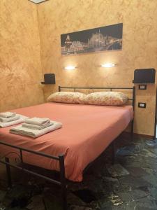 a bedroom with a bed with pink sheets and towels at Nova milanese design apartment in Nova Milanese