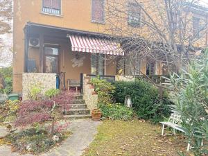 a house with an awning on the front of it at Nova milanese design apartment in Nova Milanese