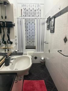 a white bathroom with a sink and a shower at Nova milanese design apartment in Nova Milanese