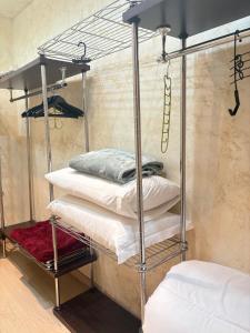 a metal bunk bed with white pillows in a room at Nova milanese design apartment in Nova Milanese