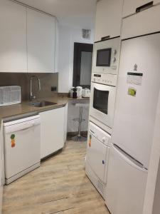 a kitchen with white appliances and a sink at Central 2 bedroom apartment with terrace in Girona