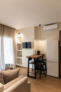 una cucina e un soggiorno con tavolo e frigorifero di Likno a Alexandroupoli