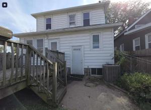 una casa blanca con una rampa que conduce a ella en S and K Properties, en Moline