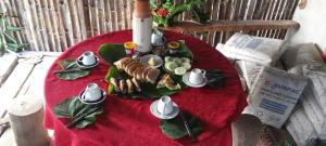 a table with a plate of food on a red table cloth at Tanna Lava View Bungalows in Lénakel +64 photos