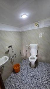 a bathroom with a toilet and a sink at Valley Homestay in Devikolam